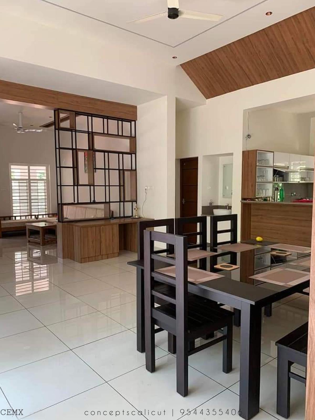 Living and dining area with a black grid partition
