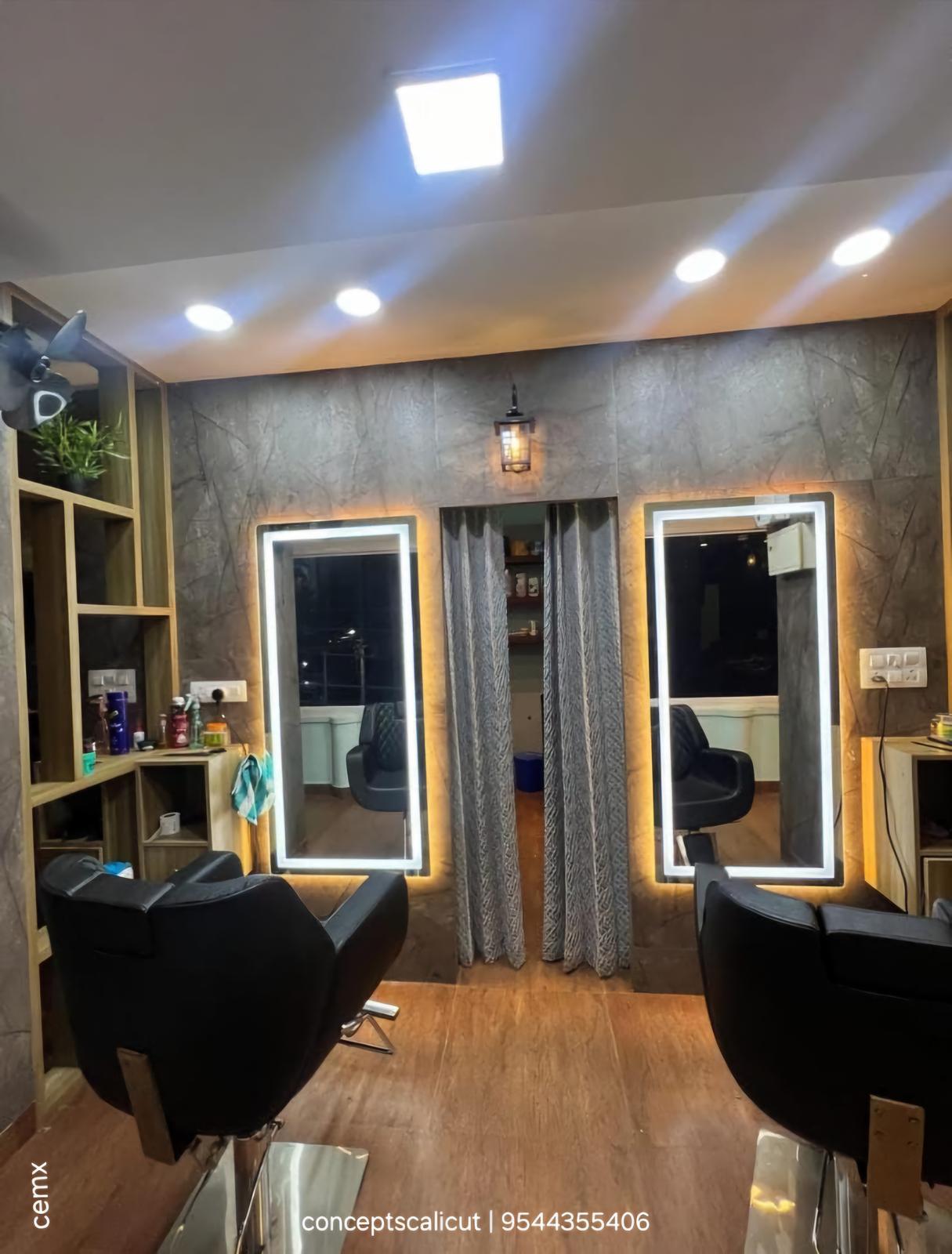 Salon with backlit mirrors and styling chairs