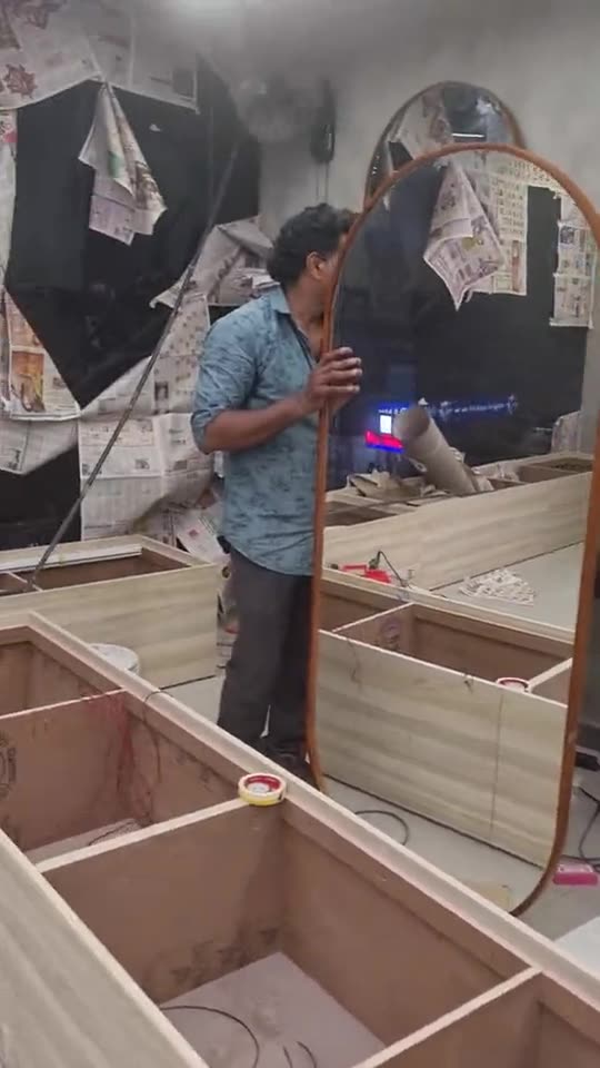 A Concepts carpenter fitting an arched mirror frame on site